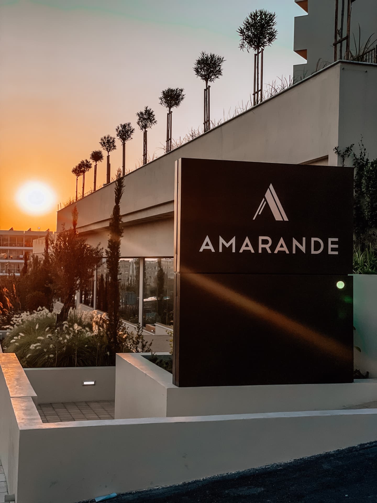 Hotel sign at sunset outside a modern building